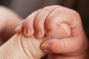 baby squeezing thumb